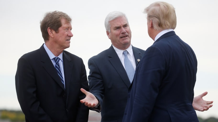 U.S. President Donald Trump talks with U.S. Rep Jason Lewis (left) and Rep. Tom Emmer (center)