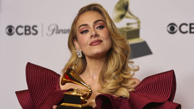 Adele poses with an award at the 65th Annual Grammy Awards