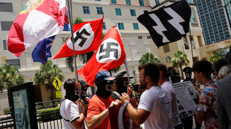 A picture of people waving Nazi swastika flags in Florida. A large group of neo-Nazis wearing red and waving flags with swastikas marched through Cranes Roost Park in Altamonte Springs, Florida, on Saturday shouting “we are everywhere.”