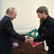 Russian President Vladimir Putin shakes hands with Chechen leader Ramzan Kadyrov.