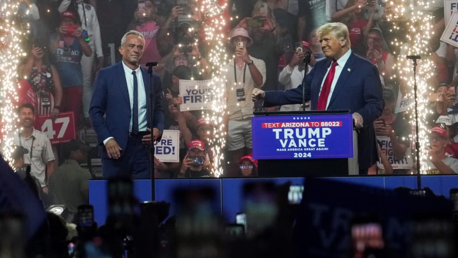 Republican presidential nominee Donald Trump welcomes former independent presidential candidate Robert F. Kennedy Jr. to the stage at a rally in Arizona.