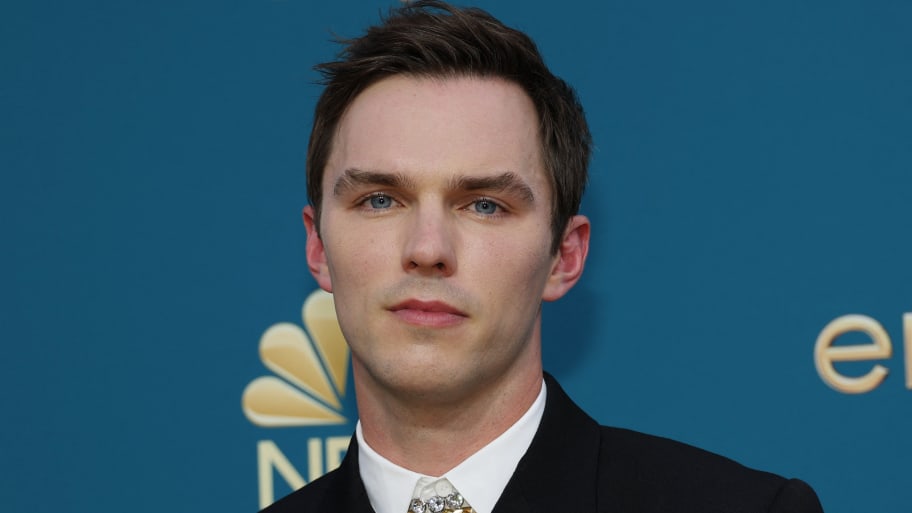 Nicholas Hoult stares forward while posing at the Emmy Awards.