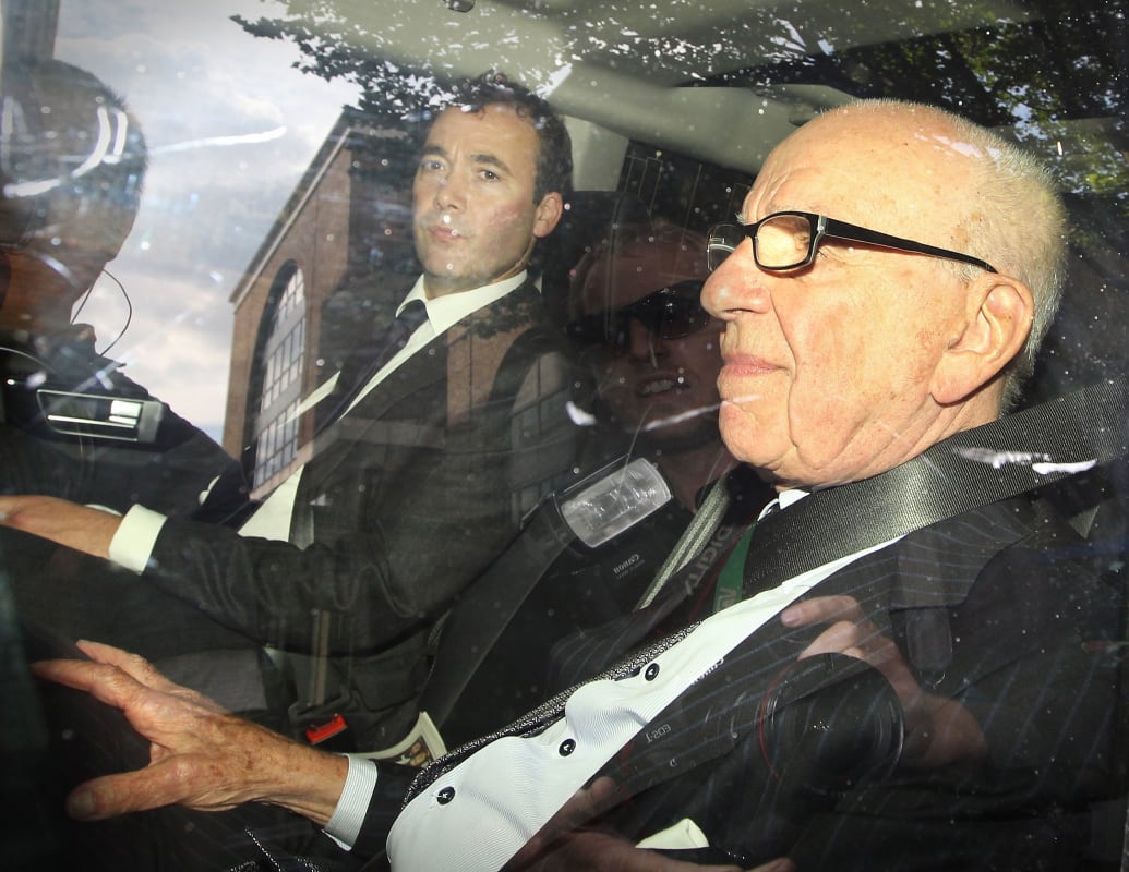 News Corp. Chairman Rupert Murdoch (R) rides with News International General Manager Will Lewis