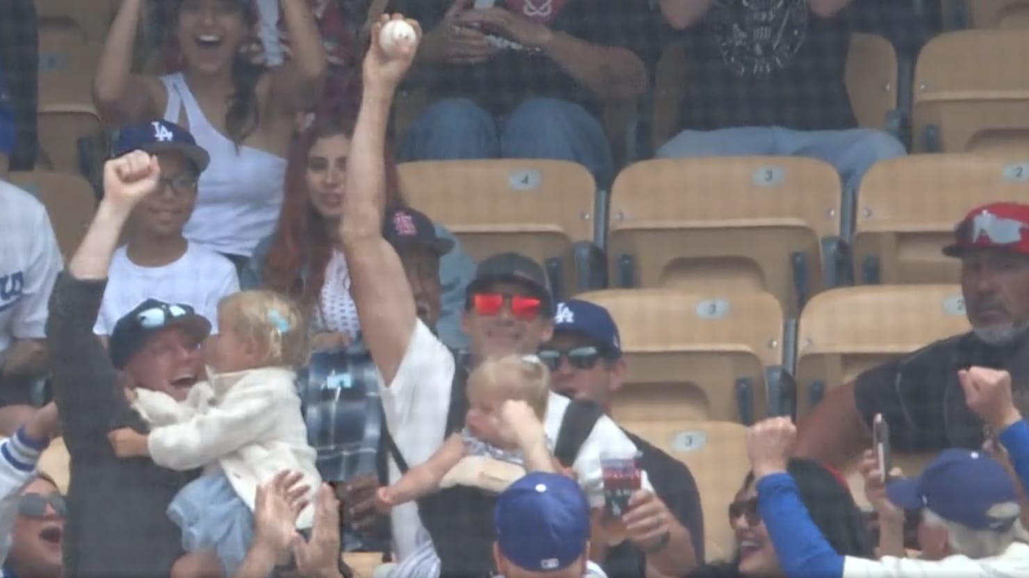 Dodgers fan catches foul ball at Sunday's baseball game while juggling baby  and a beer, viral video shows - ABC7 Los Angeles