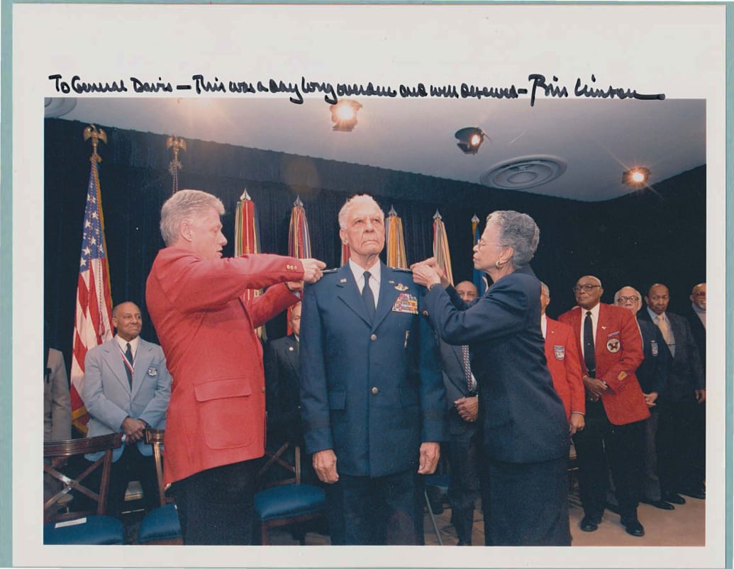A signed photo of Ben getting his 4th star pinned by Bill Clinton. 