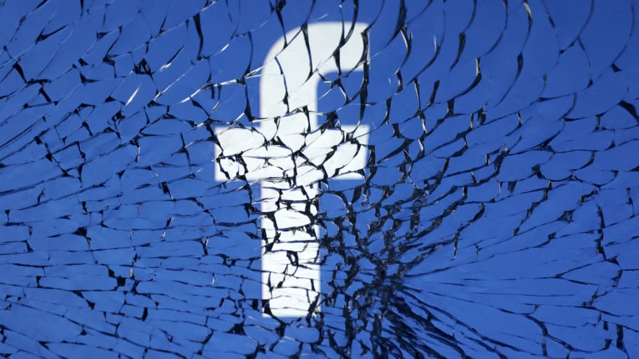 Facebook logo is seen through broken glass in this illustration taken Jan. 25, 2023. 