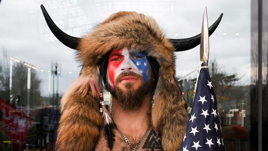 Jacob Chansley, wearing a buffalo headdress with his face painted, poses for a photo on the day of the Jan. 6 insurrection in 2021.