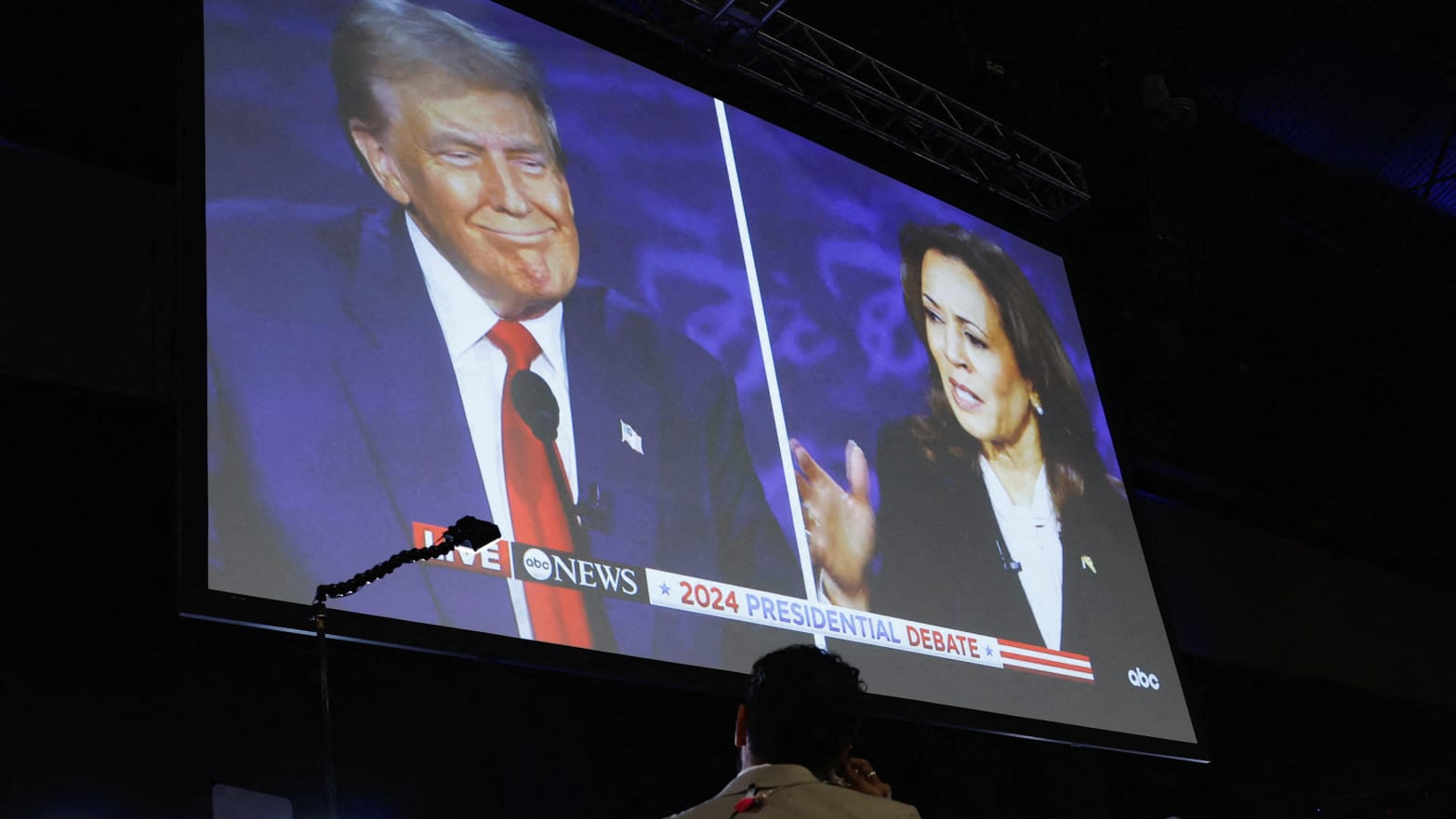 A screen displays the presidential debate hosted by ABC between Republican presidential nominee, former U.S. President Donald Trump and Democratic presidential nominee, U.S. Vice President Kamala Harris in Philadelphia, Pennsylvania