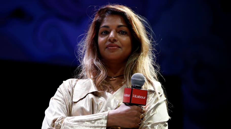 Singer M.I.A. stands on the stage at the Theatre Royal in London.