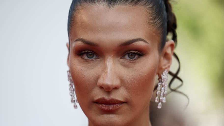 Bella Hadid looks forward while wearing earrings