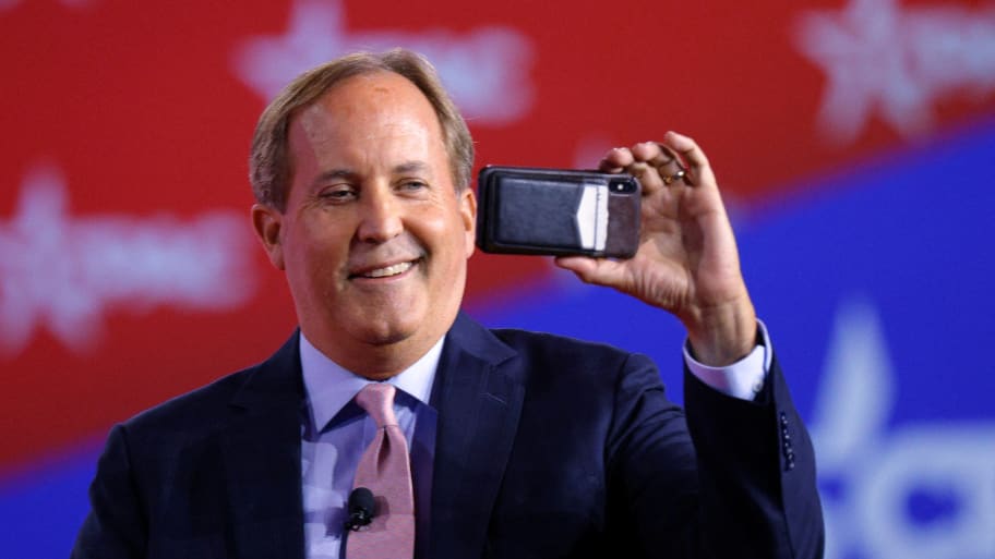 Texas Attorney General Ken Paxton takes a video of the audience before speaking at the Conservative Political Action Conference (CPAC) in Dallas, Texas, U.S., August 5, 2022.
