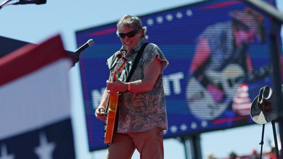 A picture of Ted Nugent performing at a Pro-Trump rally. On Friday, Nugent defended musicians Carlos Santana and Alice Cooper, who both came under fire recently for going on anti-trans rants.