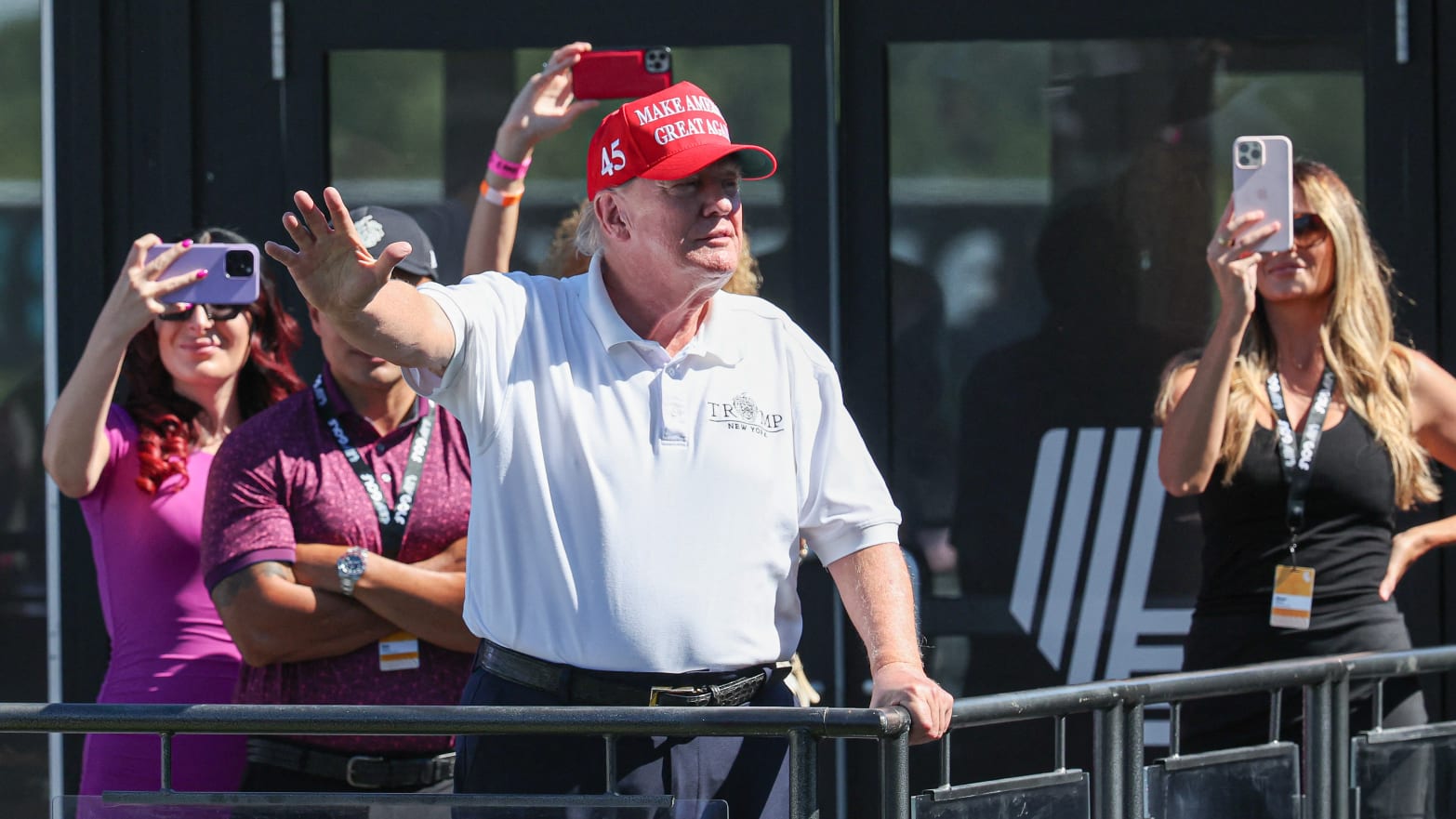 Former President Donald Trump waves to the fans during the final round of the LIV Golf Bedminster golf tournament at Trump National Bedminster.