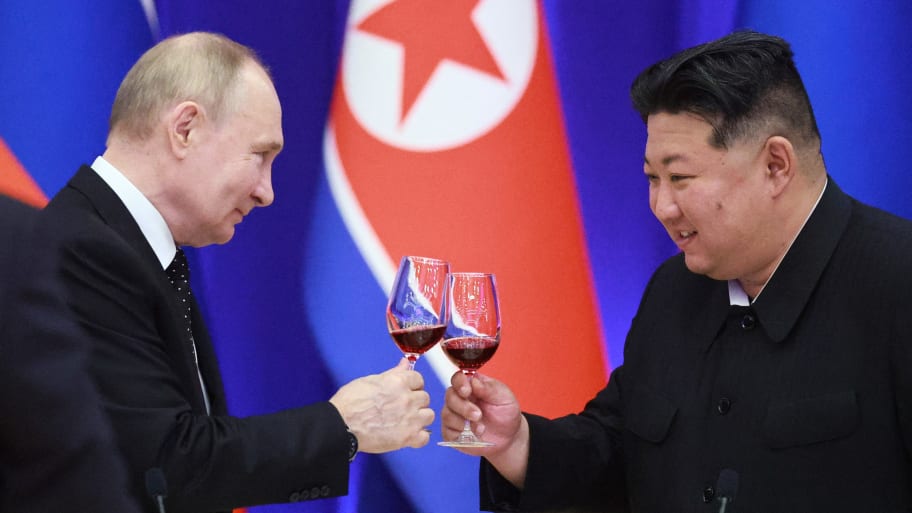 Russian President Vladimir Putin and North Korean leader Kim Jong Un toast during a reception at the Mongnangwan Reception House in Pyongyang on June 19, 2024. 