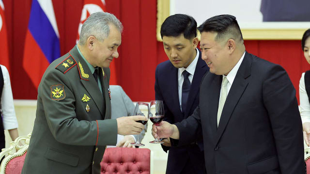Russia's Defense Minister Sergei Shoigu toasts a glass with North Korean leader Kim Jong Un.