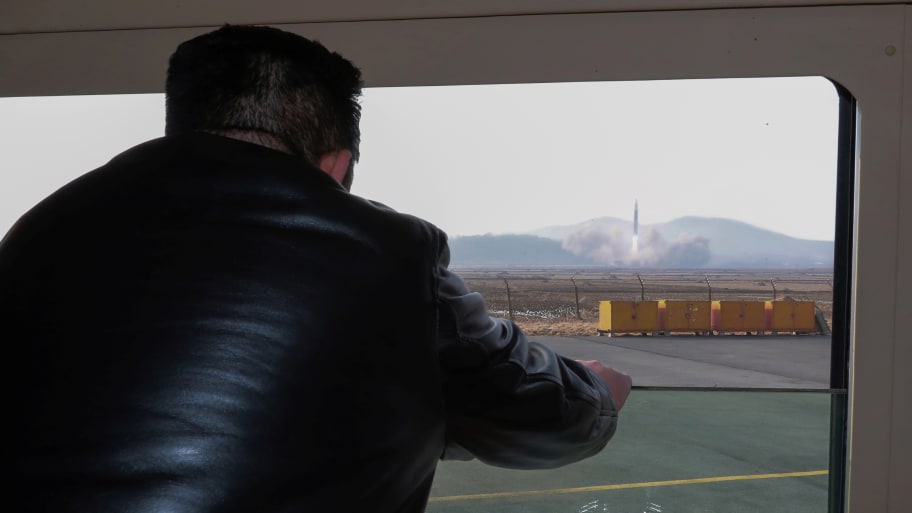 Kim Jong Un looks through a window during the test firing of what state media report is a “new type” of ICBM in this undated photo released on March 24, 2022.