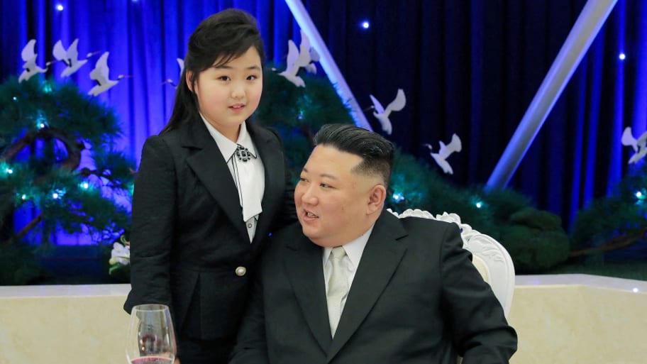 Kim Jong Un talks with his daughter Kim Ju Ae at a banquet in this photo released Feb. 8, 2023, by North Korea’s Korean Central News Agency (KCNA).  