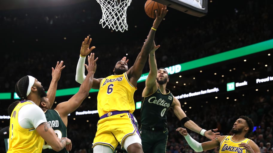 Jayson Tatum #0 of the Boston Celtics defends LeBron James #6 of the Los Angeles Lakers in the final shot of regulation play during the fourth quarter.