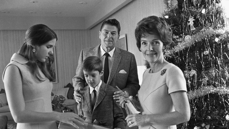 Ronald Regan and family stand with Christmas tree.