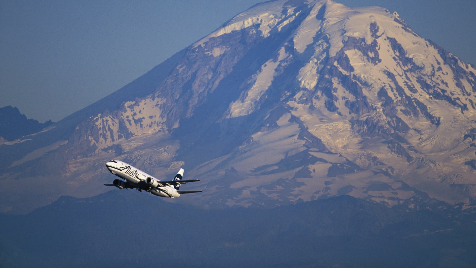 An Alaska Airlines jet passes in front of Mt. Rainier.