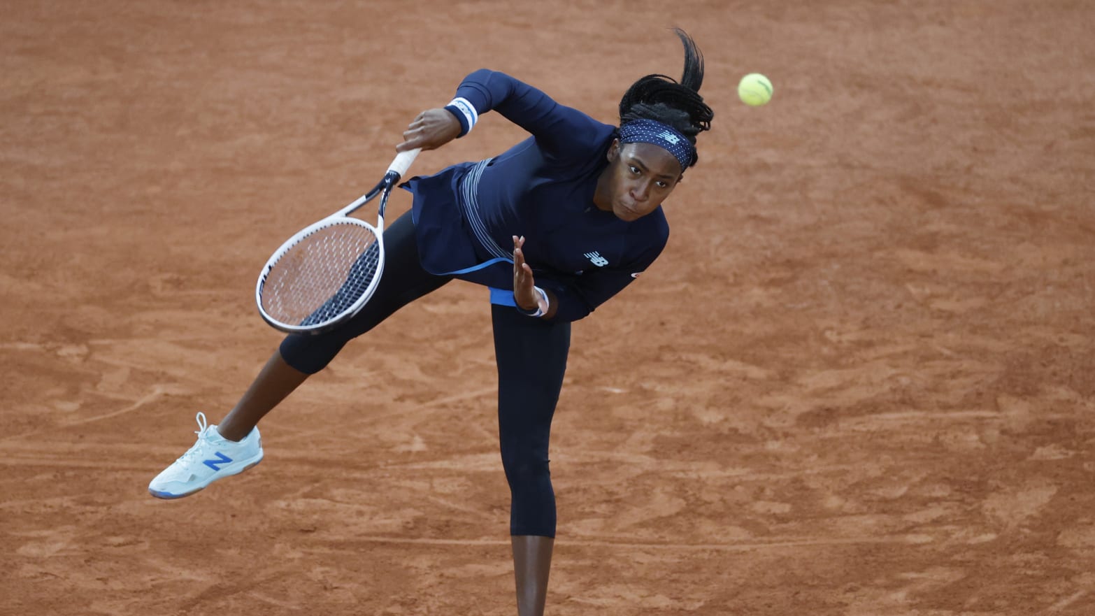 Coco Gauff serving.