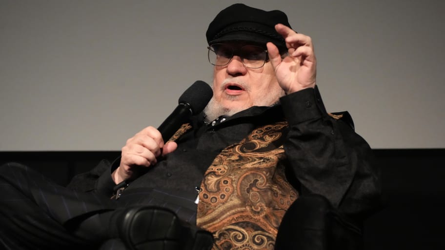 A picture of George R.R. Martin sitting. 