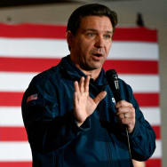 Ron DeSantis gestures as he speaks at a campaign event at The Thunderdome in Newton, Iowa