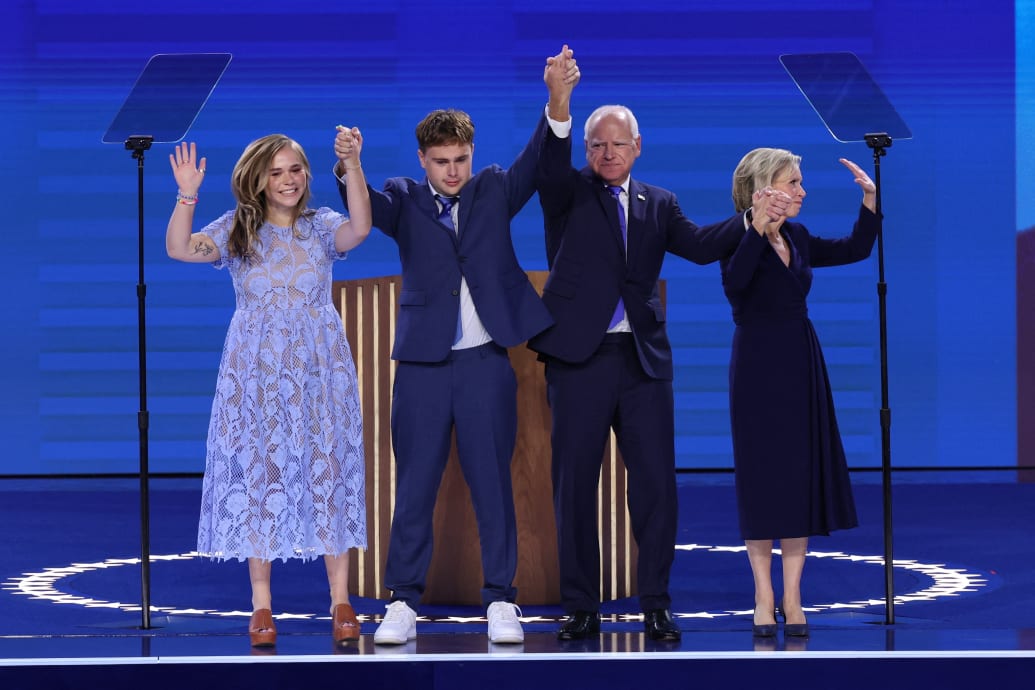 U.S. Democratic vice presidential nominee Minnesota Governor Tim Walz stands onstage with his wife Gwen, his son Gus and his daughter Hope