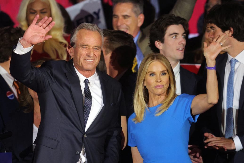 Robert F. Kennedy Jr. and his wife and actor Cheryl Hines wave to the crowd after he announced his candidacy for the Democratic presidential nomination in Boston, Massachusetts.