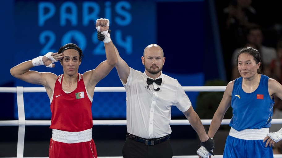 Imane Khelif of Team Algeria celebrates as she wins gold medal after defeating Liu Yang (blue) of China 