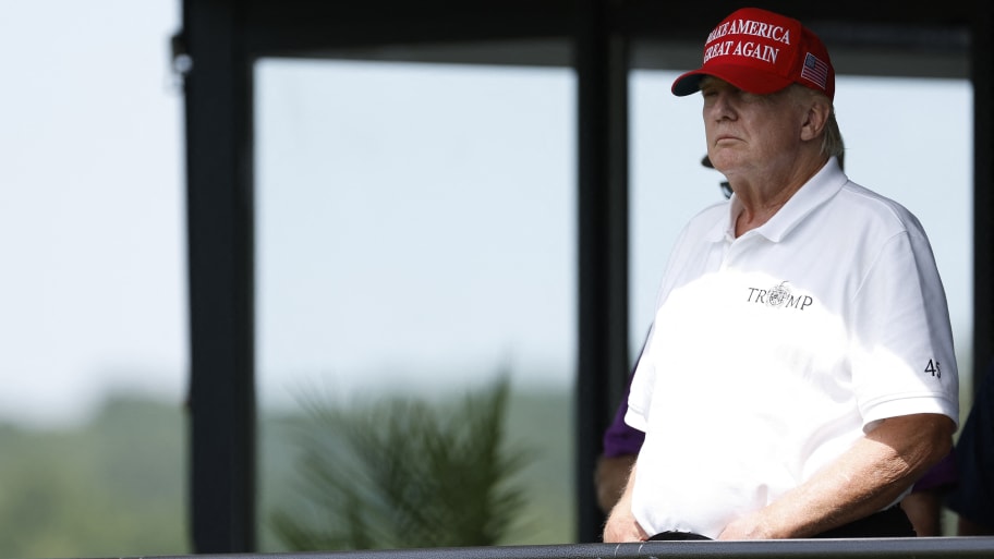 Former President Donald Trump looks on from a hospitality suite on the eighteenth green during the second round of LIV Golf Washington, D.C. golf tournament at Trump National. 