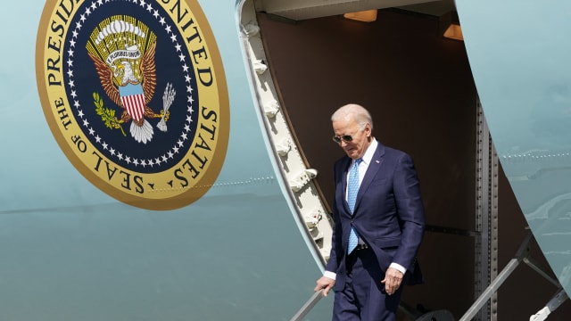 Joe Biden walks down stairs off of Air Force One.