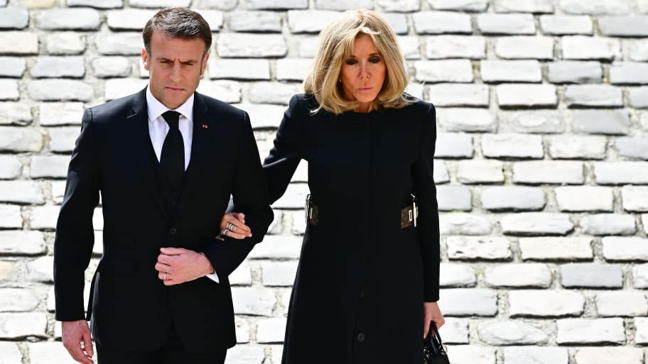France's President Emmanuel Macron (L) and his wife Brigitte Macron
