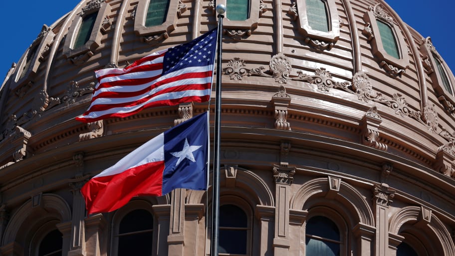 The U.S flag and the Texas State flag fly over the Texas State Capitol in Austin, Texas, U.S., March 14, 2017. 