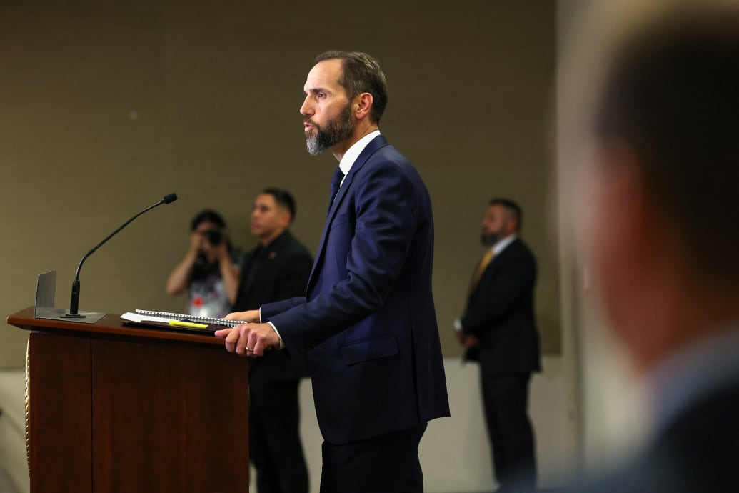 Jack Smith speaks at a podium during a press conference.