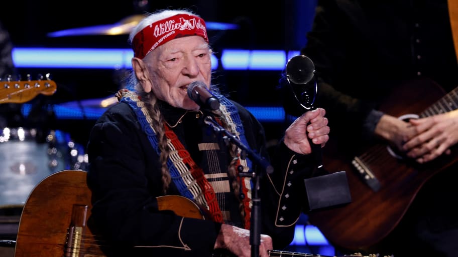 Willie Nelson receives an award on stage during the Rock & Roll Hall of Fame Induction Ceremony.