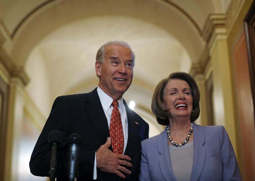 Joe Biden and Nancy Pelosi laugh together in old photo.