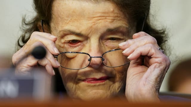 A picture of U.S. Senator Dianne Feinstein (D-CA) putting on her glasses during a Senate Judiciary Committee executive business meeting. Feinstein has reportedly been hospitalized after tripping and falling in her San Francisco home.