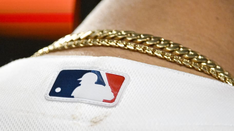 An MLB logo on the back of a player’s jersey.