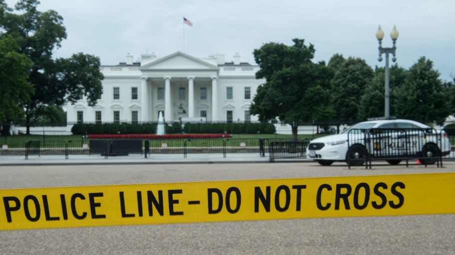 Police tape hangs along Pennsylvania Avenue across from the White House in Washington, DC, on June 15, 2017. 