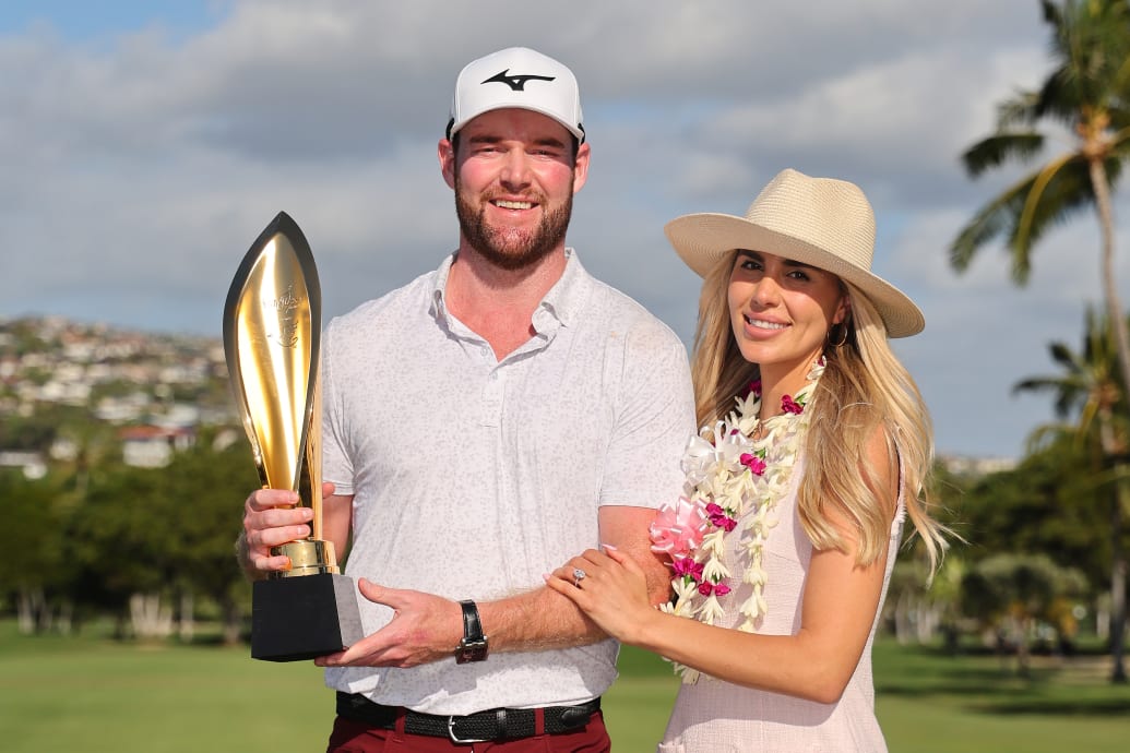 Grayson Murray of the United States and fiancee, Christiana, pose for a photo with the trophy after winning the Sony Open in January