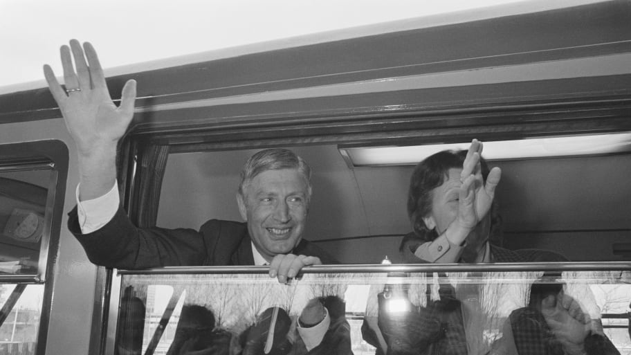 former Prime Minister Dries van Agt and wife Eugenie wave goodbye in Amsterdam, 1987