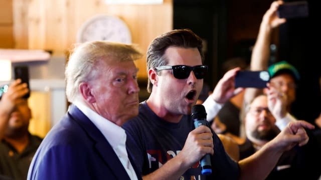 Rep. Matt Gaetz uses a microphone as Republican presidential candidate and former U.S. President Donald Trump campaigns at the Iowa State Fair in Des Moines, Iowa