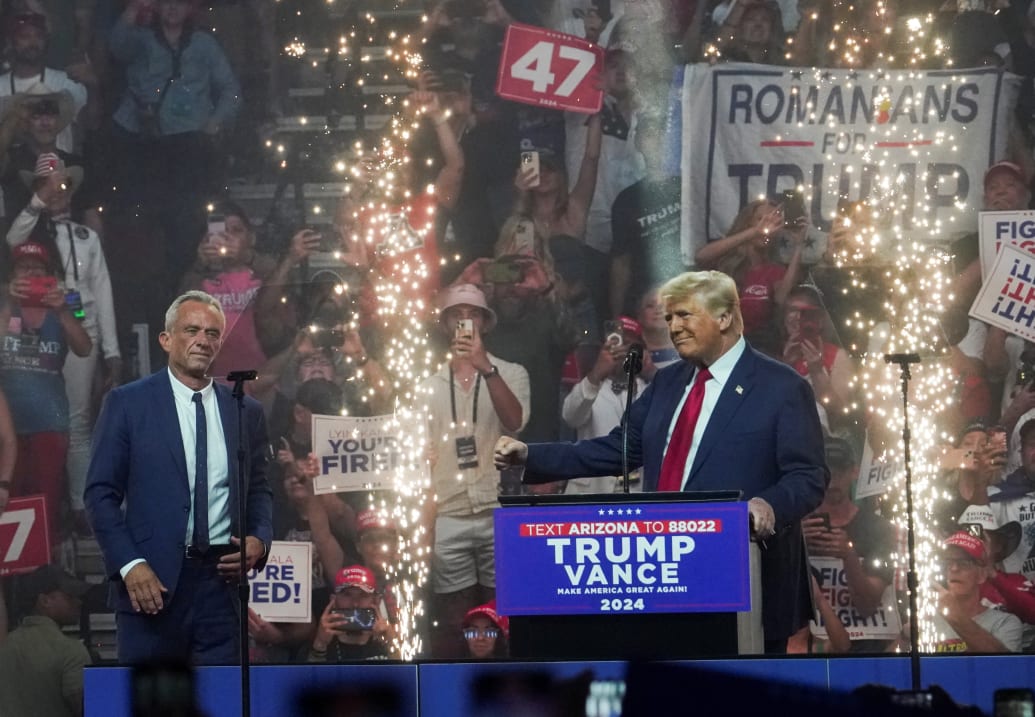 Republican presidential nominee and former U.S. President Donald Trump speaks during a rally as former independent presidential candidate Robert F. Kennedy Jr. looks on in Glendale, Arizona, U.S., August 23, 2024. 