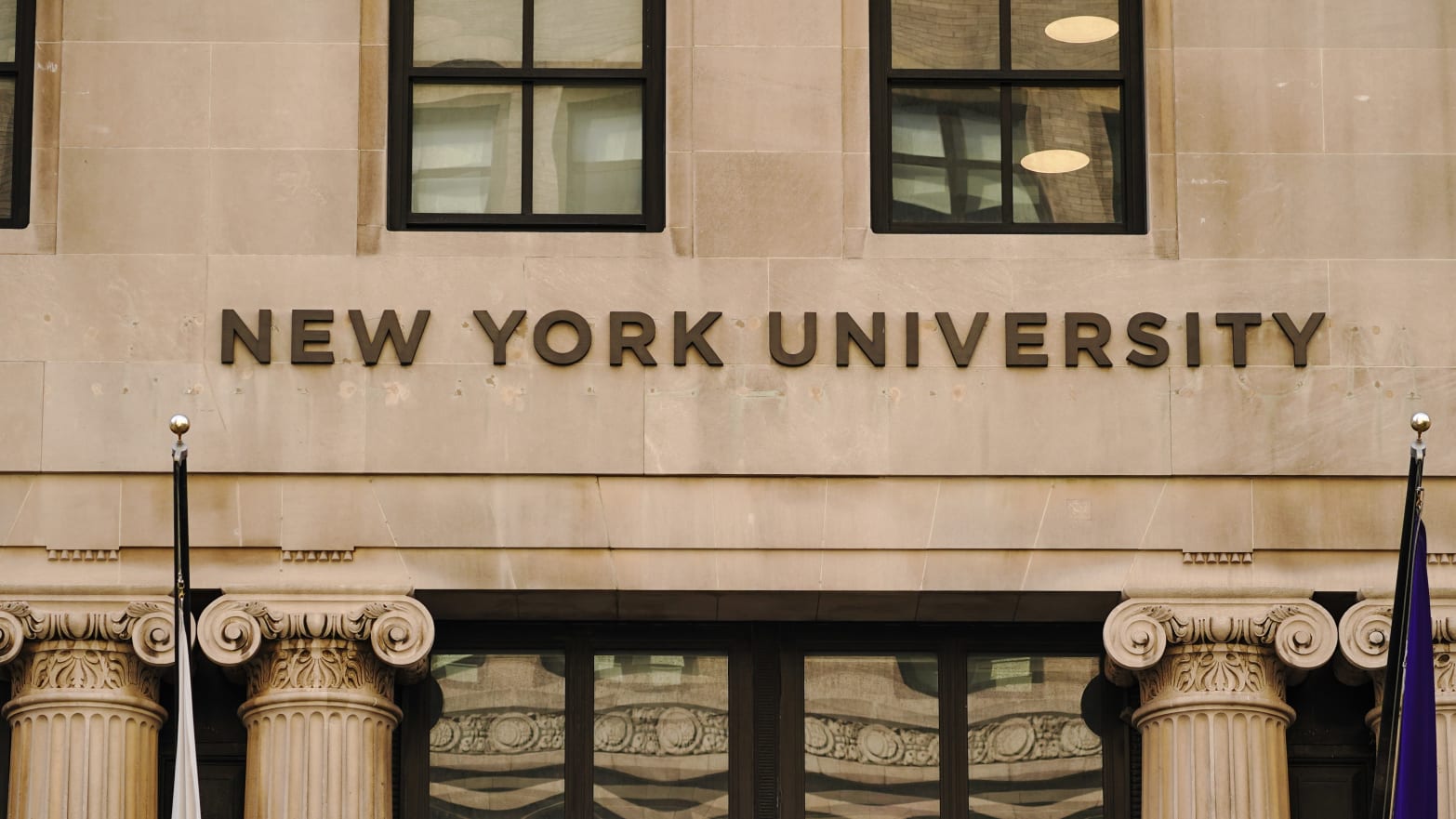 A view of New York University sign on the campus building.