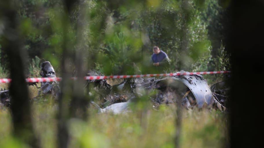A specialist works at the site of a crash of a private jet linked to Wagner mercenary chief Yevgeny Prigozhin in the Tver region, Russia, Aug. 24, 2023.