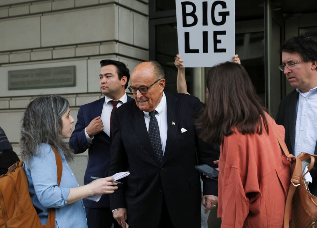 Rudy Giuliani talks to reporters as he exits U.S. District Court.