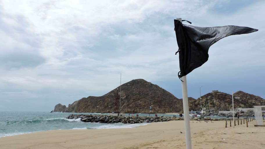 A black flag is pictured at a beach as a security measure for Hurricane Hilary in Cabo San Lucas.  