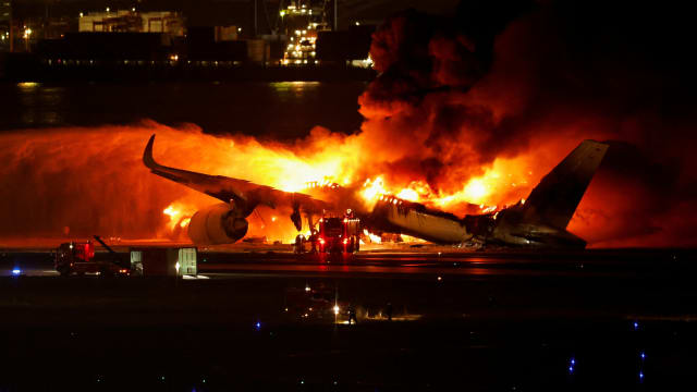 Firefighters work at Haneda International Airport after Japan Airlines’ A350 airplane caught on fire in Tokyo, Japan, Jan. 2, 2024.