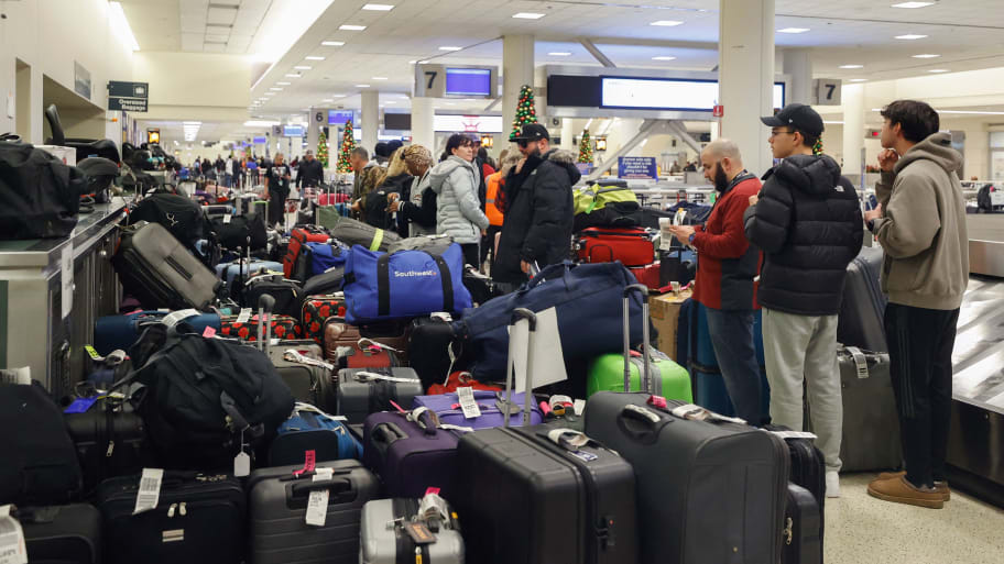 Stranded Southwest Airlines passengers looks for their luggage in the baggage claim area at Chicago Midway International Airport in Chicago, Illinois, on December 28, 2022.